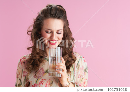 happy young female in floral dress on pink 101751018