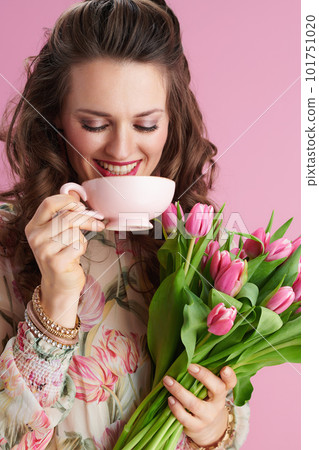 smiling stylish 40 years old woman in floral dress on pink smiling stylish 40 years old woman in floral dress on pink 101751020