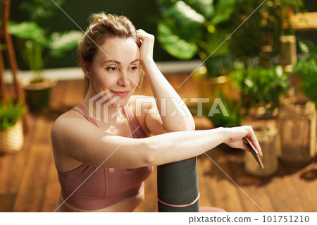 modern woman at modern green home using smartphone 101751210