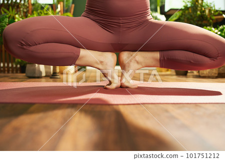 Closeup on female stretching at green home 101751212