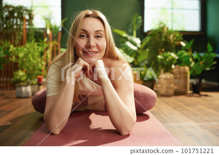 Portrait of happy modern woman doing yoga in modern green house Portrait of happy modern woman doing yoga in modern green house 101751221