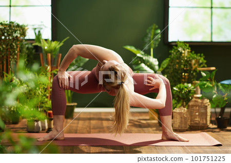 modern 30 years old woman at modern green home doing yoga modern 30 years old woman at modern green home doing yoga 101751225