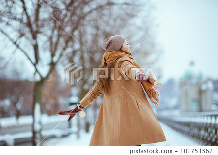 Seen from behind woman in brown hat and scarf Seen from behind woman in brown hat and scarf 101751362