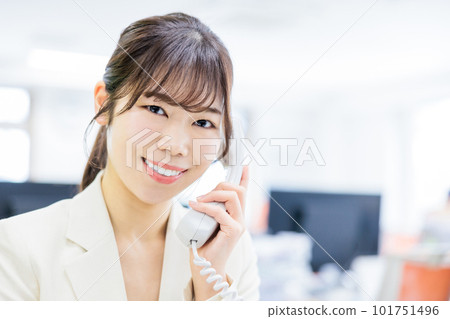 Woman receiving a phone call in the office Woman receiving a phone call in the office 101751496