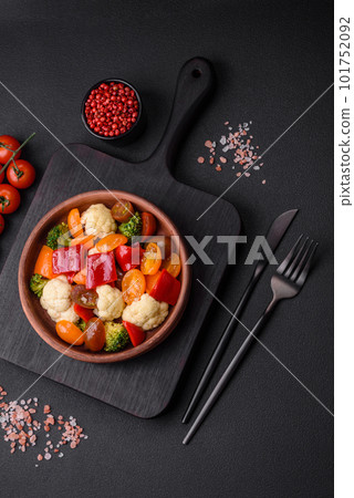 Delicious salad of fresh cherry tomatoes, sweet peppers, broccoli and cauliflower 101752092