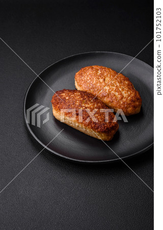 Delicious fried cutlets or meatballs from minced fish with spices and herbs Delicious fried cutlets or meatballs from minced fish with spices and herbs 101752103