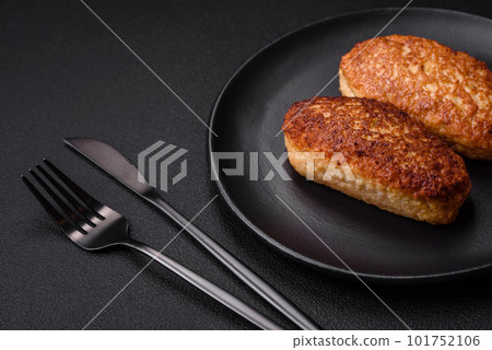 Delicious fried cutlets or meatballs from minced fish with spices and herbs Delicious fried cutlets or meatballs from minced fish with spices and herbs 101752106