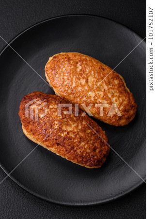 Delicious fried cutlets or meatballs from minced fish with spices and herbs Delicious fried cutlets or meatballs from minced fish with spices and herbs 101752107