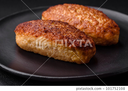 Delicious fried cutlets or meatballs from minced fish with spices and herbs Delicious fried cutlets or meatballs from minced fish with spices and herbs 101752108