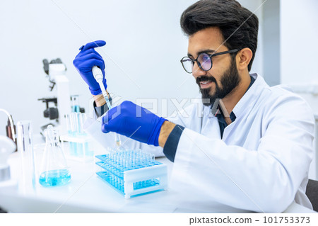 Man scientist dripping chemicals to test tubes, biochemist conducting experiments to discover drugs 101753373