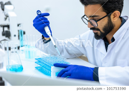 Man scientist dripping chemicals to test tubes, biochemist conducting experiments to discover drugs Man scientist dripping chemicals to test tubes, biochemist conducting experiments to discover drugs 101753390