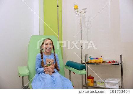 Little girl kid in hospital room having dropper with medication. 101753404