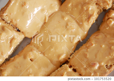top view of peanut butter and a bread on plate on black background top view of peanut butter and a bread on plate on black background 101753520