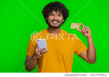 Indian man using credit bank card and smartphone while transferring money purchases online shopping Indian man using credit bank card and smartphone while transferring money purchases online shopping 101753652