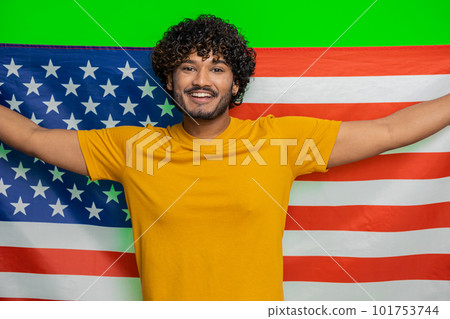 Young indian man waving and wrapping in American USA flag, celebrating, human rights and freedoms Young indian man waving and wrapping in American USA flag, celebrating, human rights and freedoms 101753744