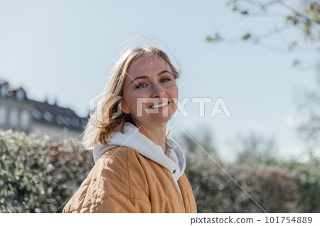 A beautiful young stylish woman walking in the city. Spring mood, dreaming and waiting, a lifestyle concept A beautiful young stylish woman walking in the city. Spring mood, dreaming and waiting, a lifestyle concept 101754889