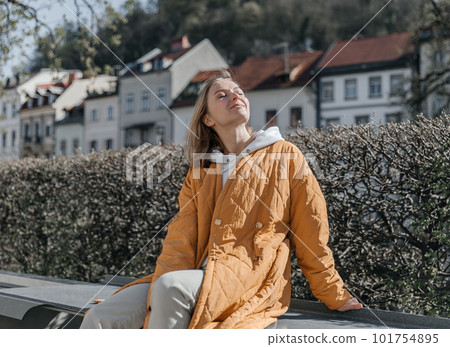 A beautiful young stylish woman walking in the city. Spring mood, dreaming and waiting, a lifestyle concept A beautiful young stylish woman walking in the city. Spring mood, dreaming and waiting, a lifestyle concept 101754895