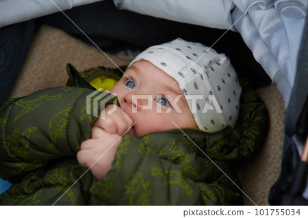 Portrait of a newborn baby boy with blue eyes in a winter cap 101755034