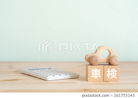 A block written as vehicle inspection, a car toy and a calculator A block written as vehicle inspection, a car toy and a calculator 101755143