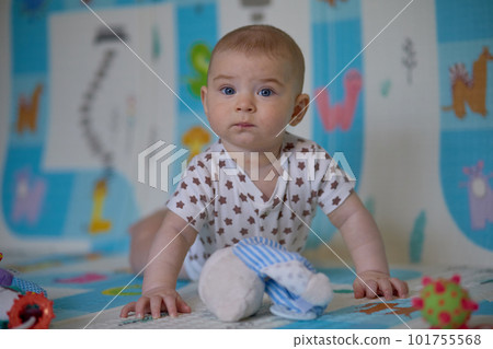 Portrait of a cute baby girl lying on the floor with toys. Portrait of a cute baby girl lying on the floor with toys. 101755568