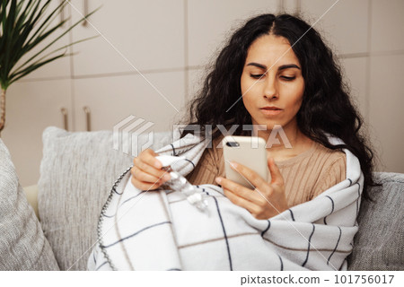 A beautiful young woman of Arab appearance conducts a consultation with a doctor on the phone. A beautiful young woman of Arab appearance conducts a consultation with a doctor on the phone. 101756017