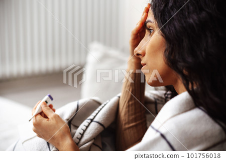Young beautiful muslim woman is puzzled by her health. Young beautiful muslim woman is puzzled by her health. 101756018