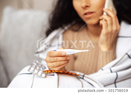 Young woman calling family doctor and consulting about treatment Young woman calling family doctor and consulting about treatment 101756019