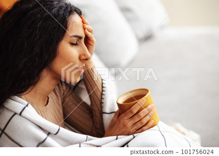 Woman experiencing severe headache due to problems and stress. 101756024
