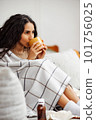 Recovery at home. Woman drinking hot drink and curing at home. 101756025