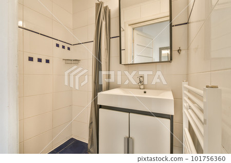 a bathroom with a sink, mirror and toilet paper dispensed on the wall next to the shower a bathroom with a sink, mirror and toilet paper dispensed on the wall next to the shower 101756360
