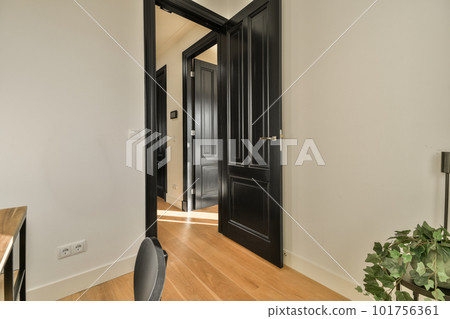 an empty room with a desk and chair in front of the door that leads to another room on the other side an empty room with a desk and chair in front of the door that leads to another room on the other side 101756361