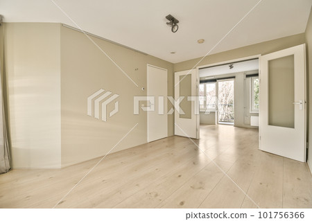 an empty living room with wood flooring and white walls in the room is very clean, but there is no light an empty living room with wood flooring and white walls in the room is very clean, but there is no light 101756366