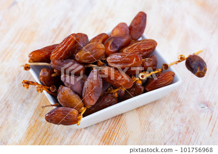 Tasty dried date on wooden table close up, mediterranean fruit Tasty dried date on wooden table close up, mediterranean fruit 101756968