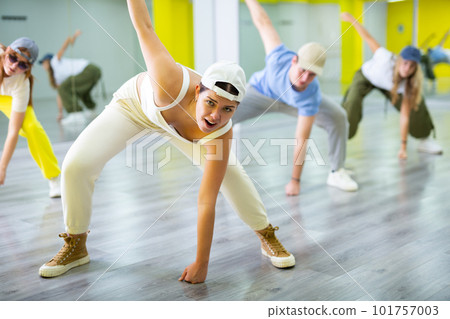 Young girl in cap dancing hip hop 101757003