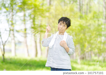 Image of senior woman refreshing in the park Image of senior woman refreshing in the park 101757101