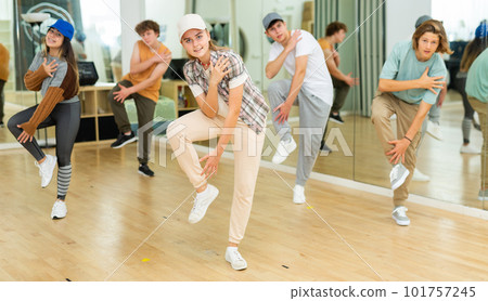 Group of teenagers rehearsing contemporary dance indoors Group of teenagers rehearsing contemporary dance indoors 101757245