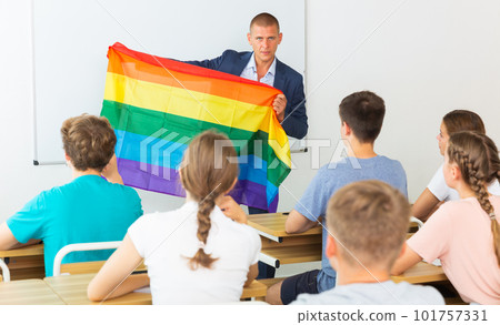 Pupils in classroom listen to teacher who explains what is LGBT 101757331