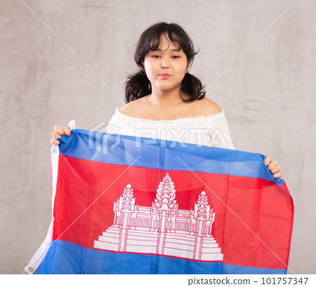 Displeased young girl holding Cambodia flag 101757347