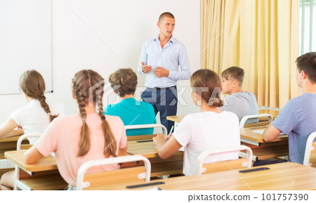 Teenager students sitting at desks 101757390