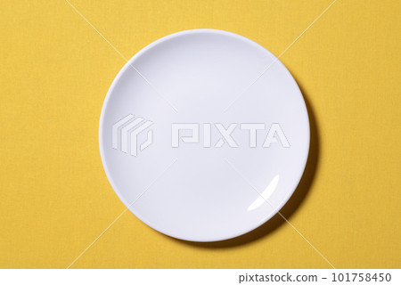 Background material of a white plate on a yellow background Background material of a white plate on a yellow background 101758450