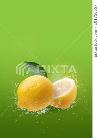 Creative layout made from lemon fruit and water splashing isolated on green background 101759357