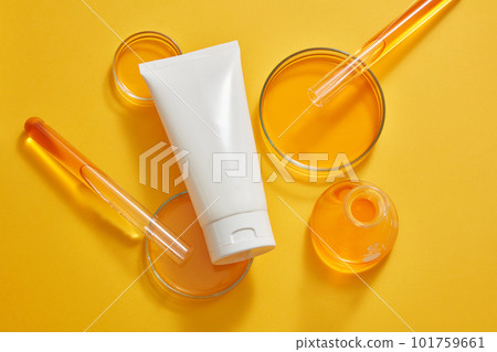 Petri dishes, test tubes and an erlenmeyer flask of orange liquid displayed with a white tube. Minimalism brand packaging mockup. Laboratory experience and research Petri dishes, test tubes and an erlenmeyer flask of orange liquid displayed with a white tube. Minimalism brand packaging mockup. Laboratory experience and research 101759661