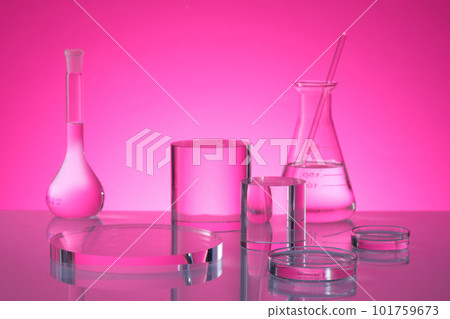Transparent podium in round and cylinder shape are decorated on pink background with laboratory glassware containing fluid. Stage showcase on pedestal Transparent podium in round and cylinder shape are decorated on pink background with laboratory glassware containing fluid. Stage showcase on pedestal 101759673
