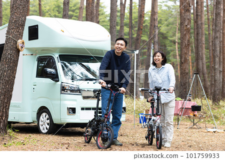 couple riding bikes at campsite 101759933