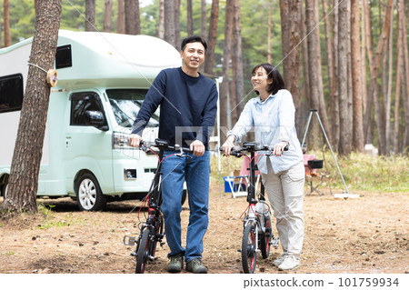 couple riding bikes at campsite 101759934