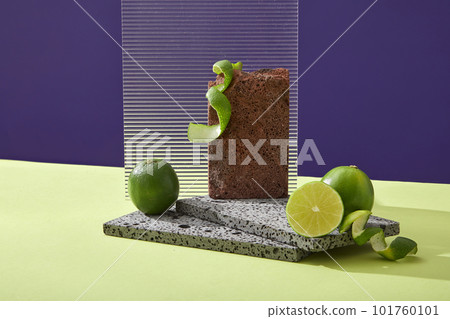 Platform for display cosmetic of lime extract with brick podiums, fresh limes and acrylic sheet on color background. Limes extract contains a lot of vitamin C and nutrients for effective skin care. Platform for display cosmetic of lime extract with brick podiums, fresh limes and acrylic sheet on color background. Limes extract contains a lot of vitamin C and nutrients for effective skin care. 101760101