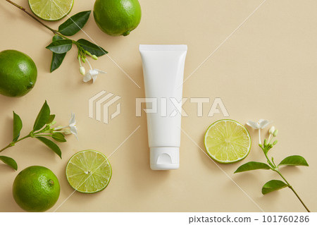 A white tube without label put in the middle with flower branches and Limes displayed around. Lime (Citrus aurantiifolia) has many benefits for skin and hair A white tube without label put in the middle with flower branches and Limes displayed around. Lime (Citrus aurantiifolia) has many benefits for skin and hair 101760286