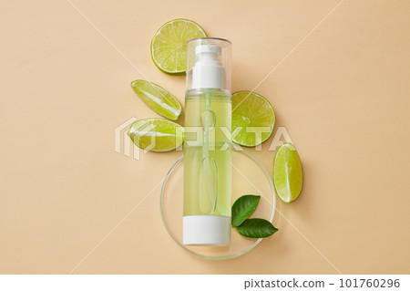 A bird-eye view of a transparent pump bottle filled with green liquid placed on a round podium. Concept for natural, organic beauty products extracted from Lime (Citrus aurantiifolia) A bird-eye view of a transparent pump bottle filled with green liquid placed on a round podium. Concept for natural, organic beauty products extracted from Lime (Citrus aurantiifolia) 101760296