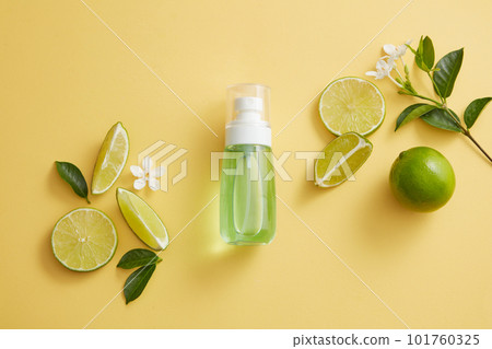 Green liquid is contained inside a pump bottle dispenser decorated with Lime slices and a flower branch. Empty label to promote beauty product extracted from Lime (Citrus aurantiifolia) Green liquid is contained inside a pump bottle dispenser decorated with Lime slices and a flower branch. Empty label to promote beauty product extracted from Lime (Citrus aurantiifolia) 101760325
