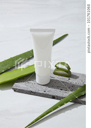 Mockup scene for cosmetic with white plastic tube unlabeled placed on gray stone and fresh aloe vera on white background. Aloe vera gel provides water, replenishes moisture, and moisturizes the skin. Mockup scene for cosmetic with white plastic tube unlabeled placed on gray stone and fresh aloe vera on white background. Aloe vera gel provides water, replenishes moisture, and moisturizes the skin. 101761068